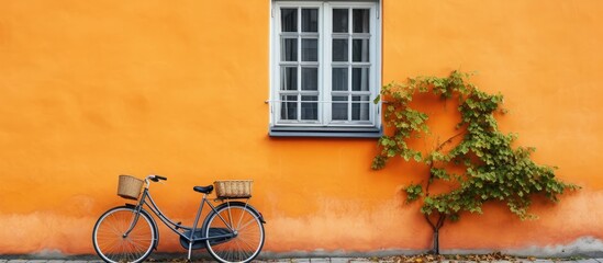 Poster - Vintage bike with basket leaning on city wall, reflecting Copenhagen's charm. with copy space image. Place for adding text or design