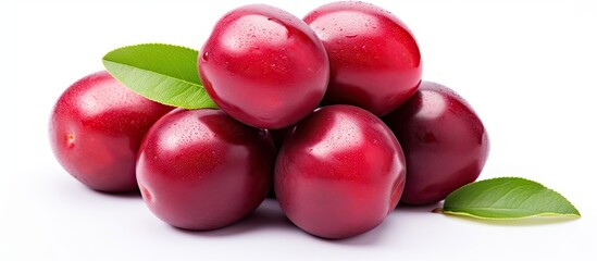 Poster - Ripe and juicy red plums arranged together with fresh green leaves on a clean white surface. with copy space image. Place for adding text or design