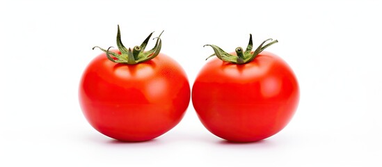 Wall Mural - A pair of red ripe tomatoes resting next to each other on a clean white surface. with copy space image. Place for adding text or design