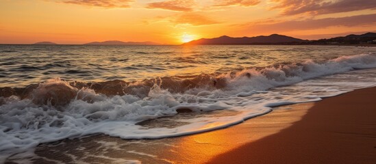 Aufkleber - The sun setting over the sea, casting a warm glow over the waves crashing onto the sandy beach. with copy space image. Place for adding text or design