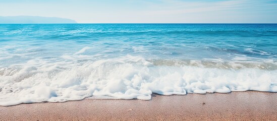 Aufkleber - A view of the seaside with a wave rolling toward the sandy shore, setting a backdrop for a summer vacation theme. with copy space image. Place for adding text or design