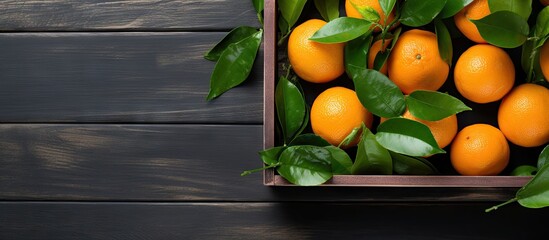 Fototapete - A selection of ripe oranges stored in a wooden box placed on a table. with copy space image. Place for adding text or design