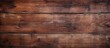 © vxnaghiyev - Weathered wood surface with a rustic brown stain, showing an aged and uneven texture pattern in the background. with copy space image. Place for adding text or design