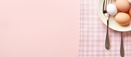 Poster - A bowl filled with eggs, paired with a fork and spoon, placed on a pink tablecloth. Plate, utensils, and egg set on pastel pink background for an Easter menu concept. with copy space image