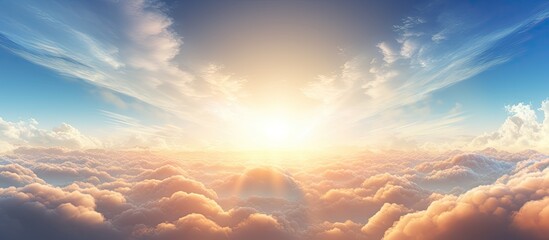 Fototapete - Bright sun casting rays over fluffy clouds during sunrise, creating a stunning view. with copy space image. Place for adding text or design