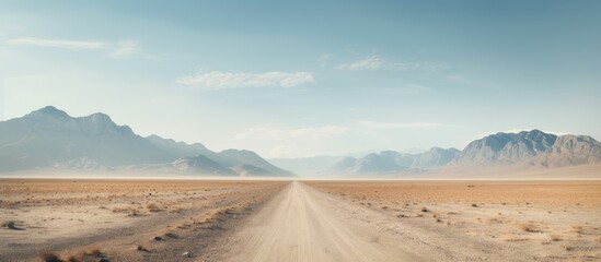 Poster - Truck traversing a dusty path through desert terrain towards towering mountains in the distance. with copy space image. Place for adding text or design