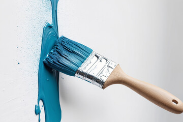 Paint brush with color for house renovation and wall painting. Hand painted stroke of blue paint brush isolated on white background.