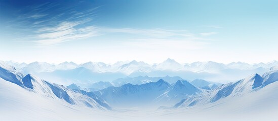 Naklejka na meble Snow-covered peaks under a clear blue sky with fluffy clouds, creating a picturesque winter scene. with copy space image. Place for adding text or design