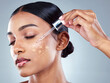 © peopleimages.com - Woman, skincare or serum with dropper for beauty, vitamin a or hydration on white background in studio. Face oil, overlay and dermatology for hyaluronic acid, cosmetics or collagen facial on girl