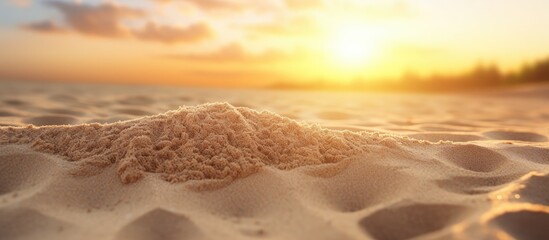Aufkleber - Sand pile with textured surface illuminated by warm sunset light on a peaceful beach setting. with copy space image. Place for adding text or design