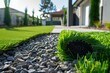 © ylivdesign - Closeup of a rolledup synthetic grass section against a landscaped home garden background