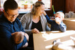 © Serena Burroughs/Stocksy - happy family with newborn baby in their home in the morning
