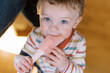 © Serena Burroughs/Stocksy - cute toddler chewing on a spatula at home
