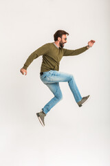 Wall Mural - handsome bearded stylish man jumping running