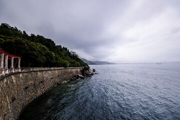 Wall Mural - View on Miramare castle on the gulf of Trieste on northeastern Italy. Long exposure image technic with reflection on the water