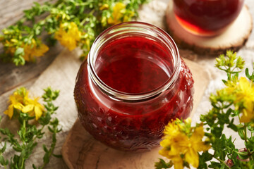 Wall Mural - A jar of red oil made from fresh St. John's wort flowers