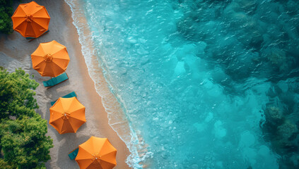 orange beach umbrella and turquoise loungers on the sandy seashore with waves, top view, sunlight, photo from drone.