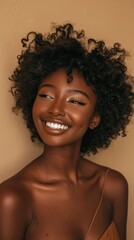 Wall Mural - A woman with curly hair is smiling and looking at the camera