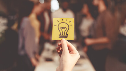 Poster - New idea concept. Business team discussing startup project, picture of light bulb on foreground
