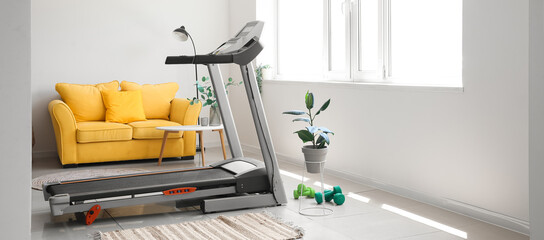 Canvas Print - Interior of light living room with treadmill and yellow sofa