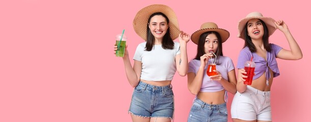 Poster - Beautiful young women in beach hats, with sunglasses and cocktails on pink background with space for text