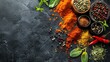 © stocker - A variety of spices and herbs on a dark background. The spices are in bowls and the herbs are scattered around them.
