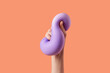 © Yaroslav Danylchenko/Stocksy - Human hand queezing purple elastic material and feeling softness