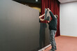 © Ezequiel Giménez/Stocksy - Anonymous man handing over LED display panel