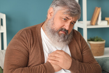 Poster - Portrait of sad senior man in living room, closeup