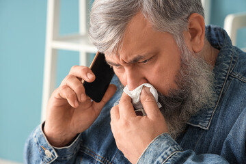 Poster - Portrait of crying senior man talking by phone at home, closeup