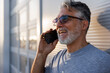© Jovo Jovanovic/Stocksy - Happy technician talking on cellphone at industry