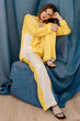 © Tania Cervian/Stocksy - Charming woman sitting on chair