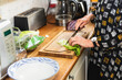 © Diego Martin/Stocksy - Senior woman preparing salad in kitchen
