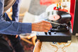 © Diego Martin/Stocksy - Close up of a senior man playing to vinyl disc at home