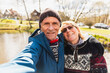 © Diego Martin/Stocksy - Happy senior couple taking a selfie photo