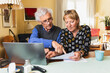 © Diego Martin/Stocksy - Senior citizen sitting at home paying family bills together