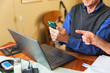 © Diego Martin/Stocksy - Senior citizen sitting at home paying family bills together