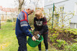 © Diego Martin/Stocksy - Senior couple cutting weeds and cleaning up at garden