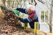 © Diego Martin/Stocksy - Senior man cleaning up on his garden