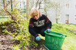© Diego Martin/Stocksy - Senior woman cutting weeds at her backyard