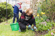 © Diego Martin/Stocksy - Senior woman cutting weeds at her backyard
