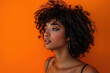 © Magnimage - Beautiful Mixed Race African American Asian Caucasian Woman Isolated on a orange Background Attractive Female Confident Elegant Stylish Ethnic Cultural Portrait Studio Photography