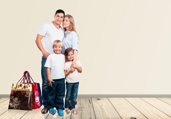 Wall Mural - young parents with children and shopping bags