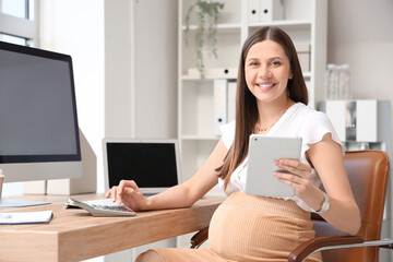 Sticker - Young pregnant businesswoman with tablet computer and calculator working at table in office