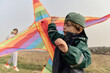 © Iuliia Versta/Stocksy - Mom and her son fly a kite at sunset