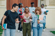 © Zamrznuti tonovi - Diverse students near university building entrance walking towards camera