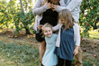 © Serena Burroughs/Stocksy - smiling young family outdoors in october