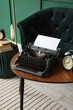 © Pixel-Shot - Vintage typewriter with alarm clock on table in living room