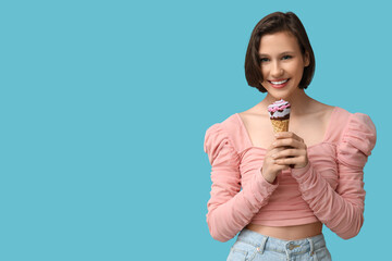 Poster - Beautiful young woman with sweet ice-cream in waffle cone on blue background