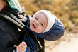 © Serena Burroughs/Stocksy - young mother walking with infant son in california with baby carrier